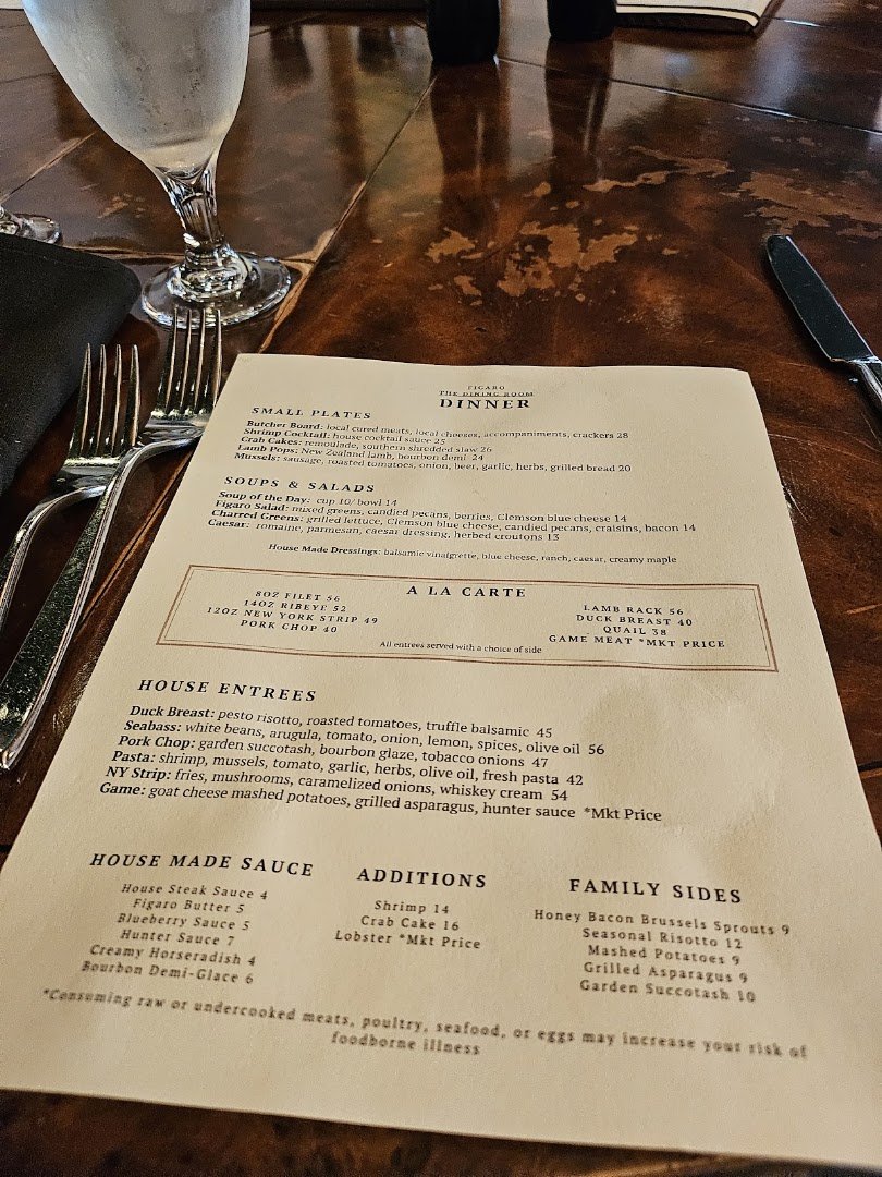 Historic interior with polished wood and formal place settings.